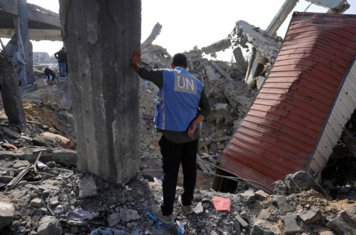 a_un_worker_stands_amid_the_rubble_of_an_unrwa_school-turned-shelter_heavily_damaged_overnight_by_israeli_strikes_afp_or_licensors